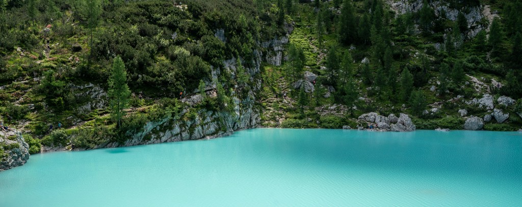 Hikers on the rocky trail approaching Lago di Sorapis in the Dolomites, Italy