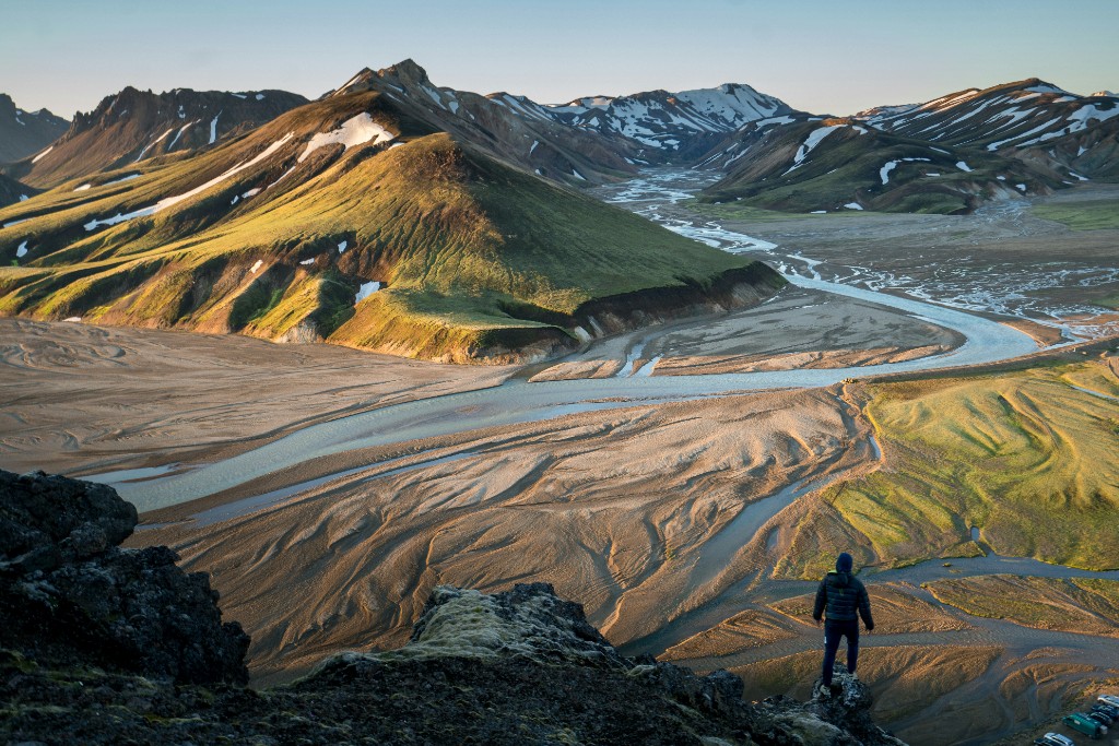 Hikers relaxing in a geothermal hot spring at Landmannalaugar, Iceland