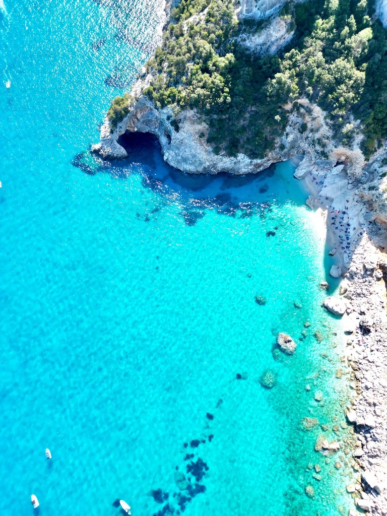 Overhead view of Cala Goloritzé cove, Sardinia, with turquoise water and small boats