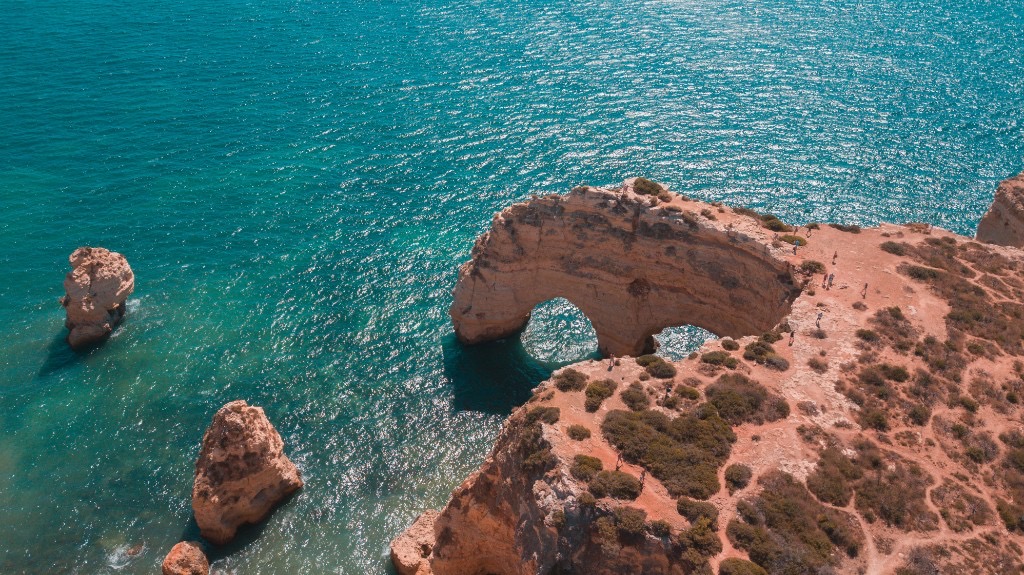 Natural rock arch and turquoise water at Praia de Marinha, Algarve, Portugal