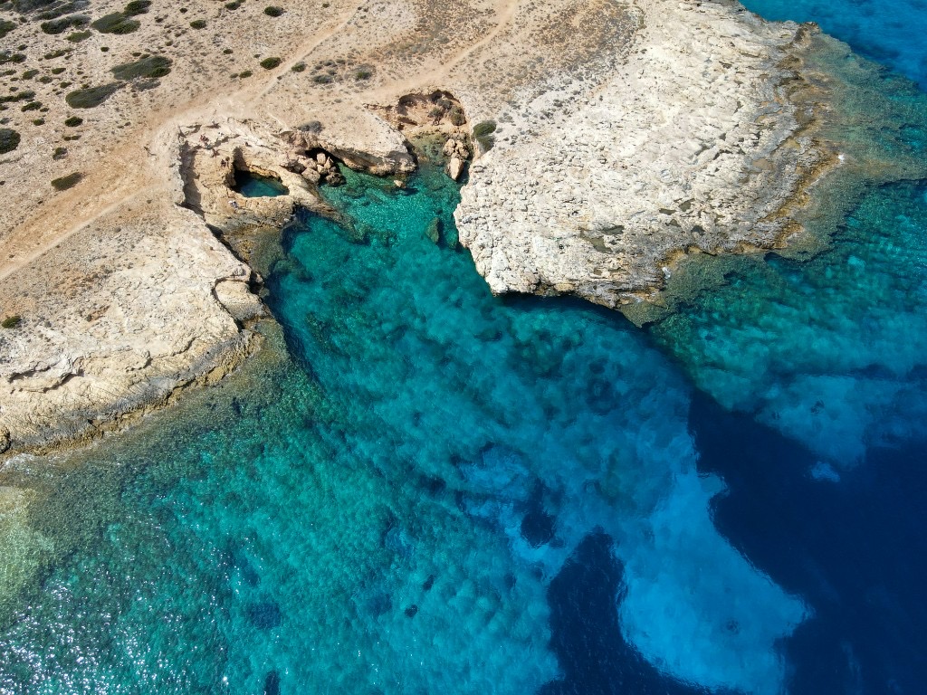 Shallow turquoise water and white sand beach at Pori, Koufonisia, Greece